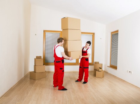 Staff using safe lifting methods during a house move